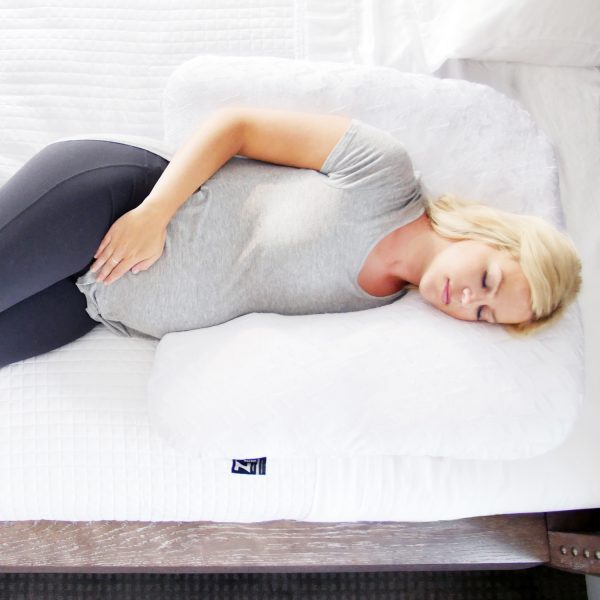 woman sleeping on the Malouf Horseshoe Pregnancy Pillow