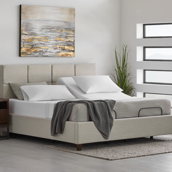E255 Adjustable Base lifestyle shot with bed frame, headboard, and bed linens - split king